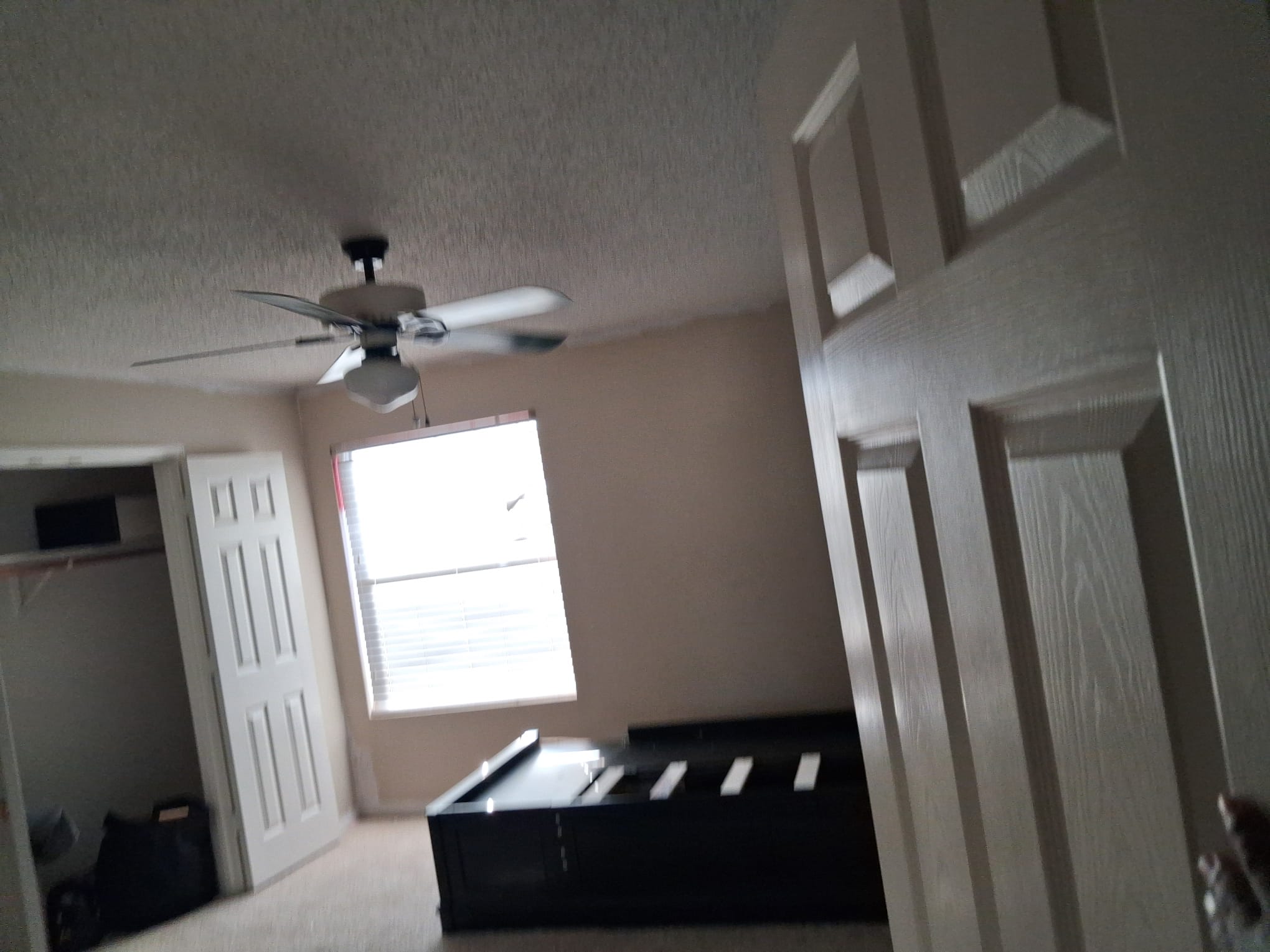 Bedroom partly cleared with a bed frame remaining