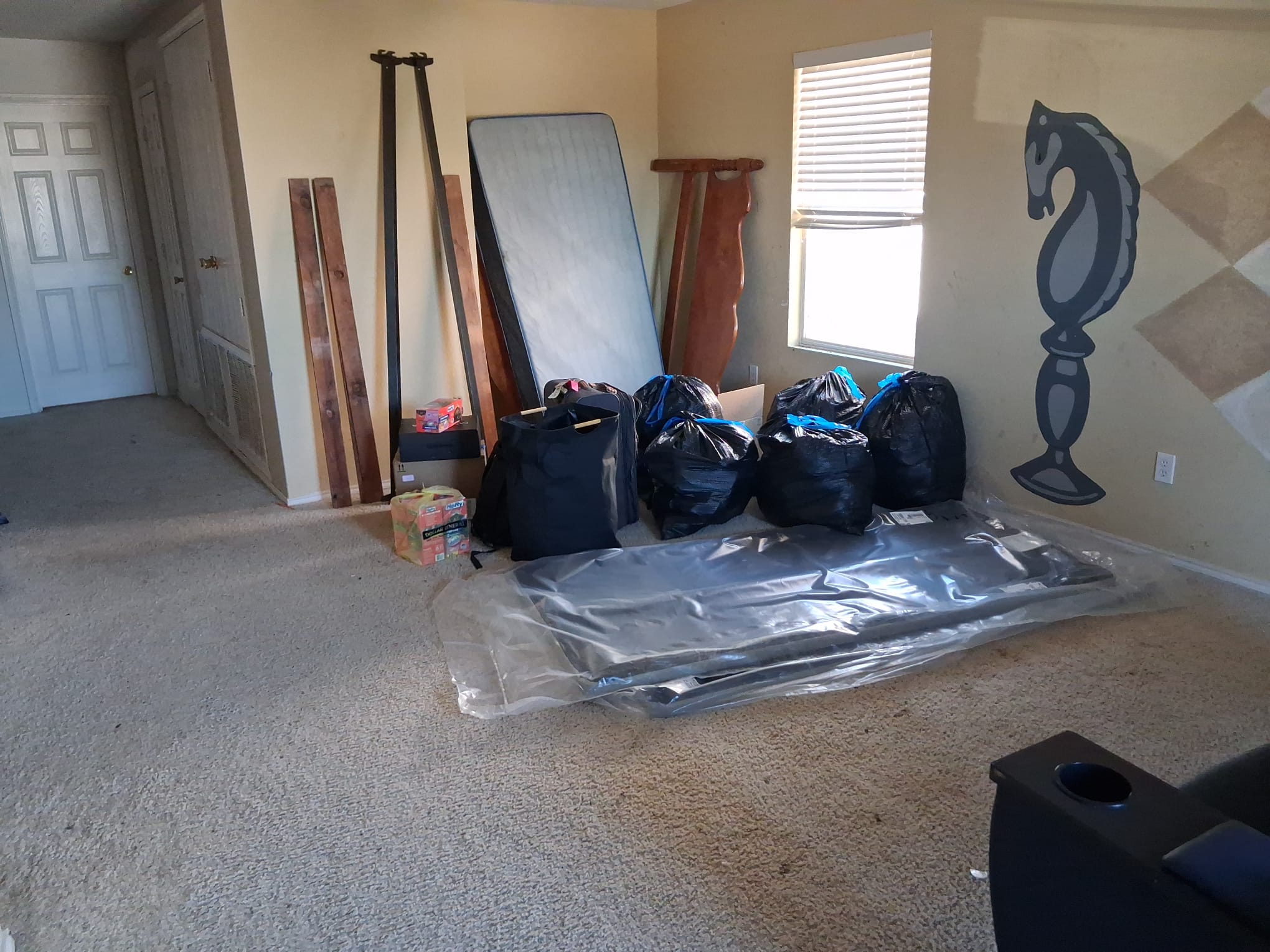 Removal bags and household furniture staged for hauling